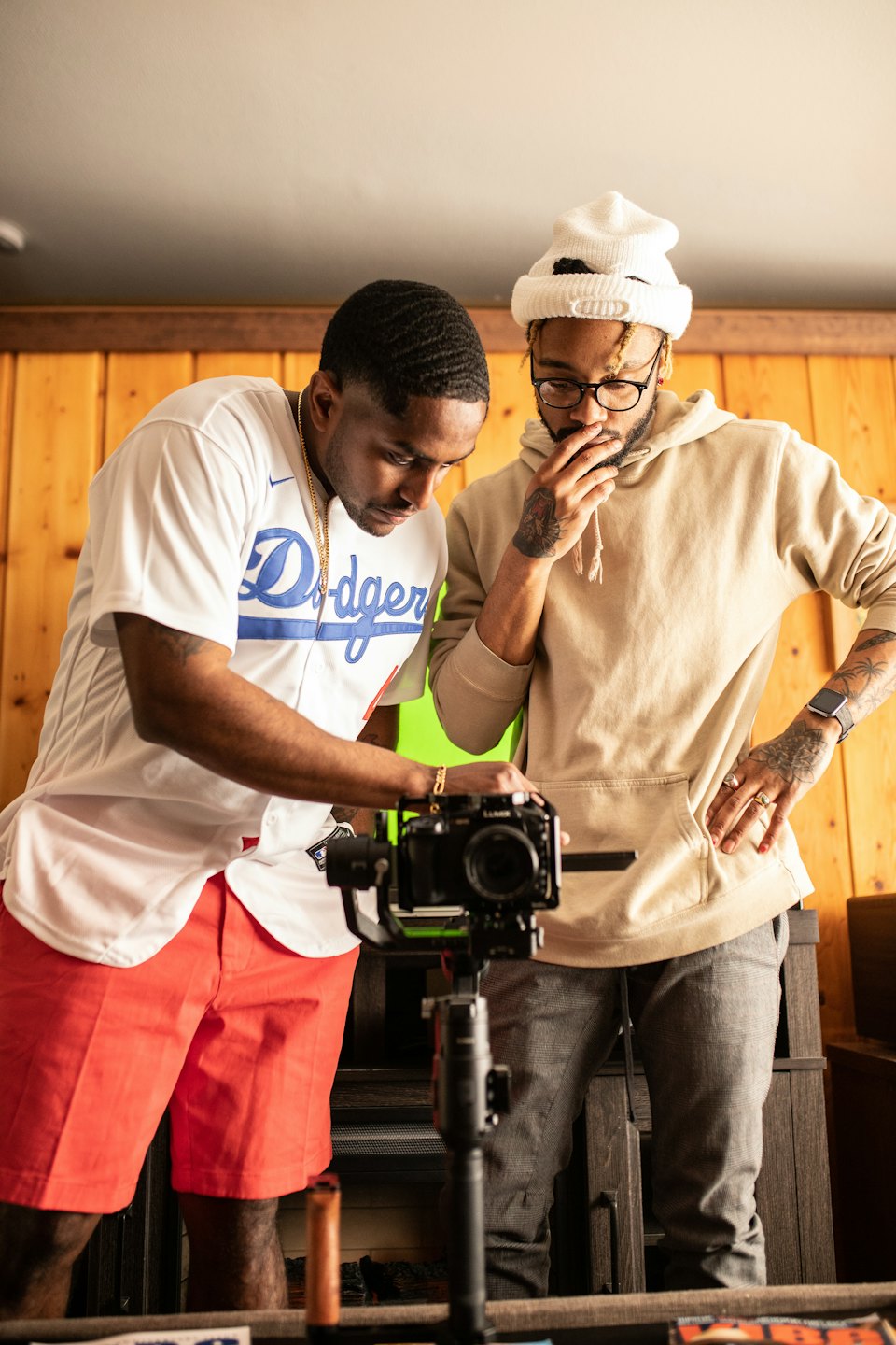 Two men collaborate on video production with a camera gimbal.